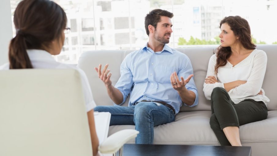 Therapist listens as couple discuss the issues in their relationship.